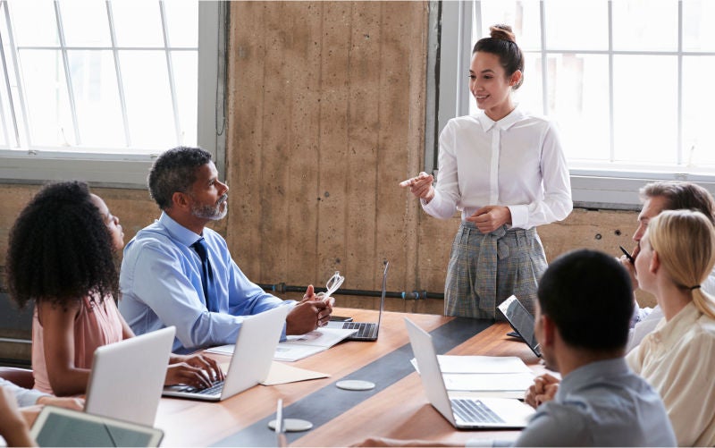 Young professional leading office team meeting