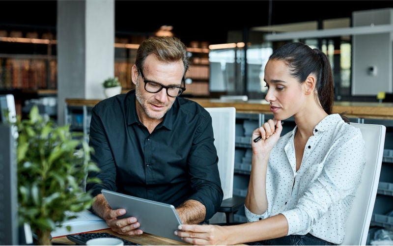 coworkers looking at laptop