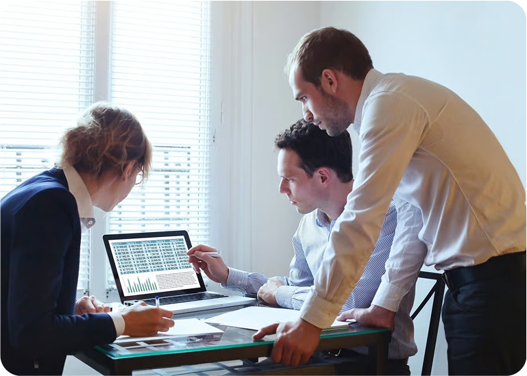 Workers looking at laptop screen