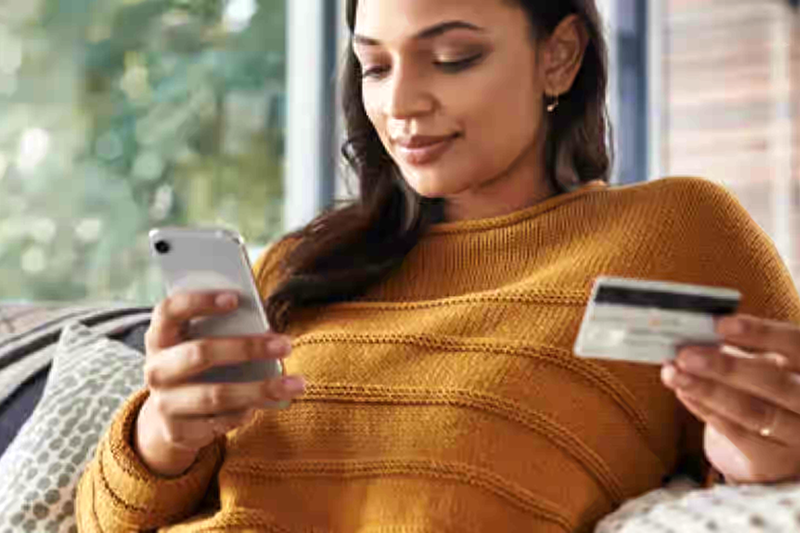 Woman with smartphone and card