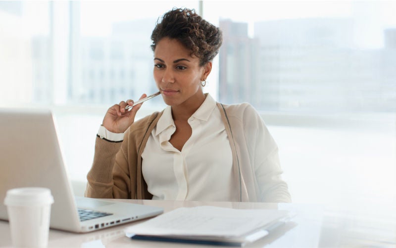embedded payments hero of woman looking at laptop