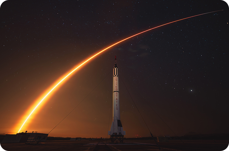 Rocket launch arc over night sky