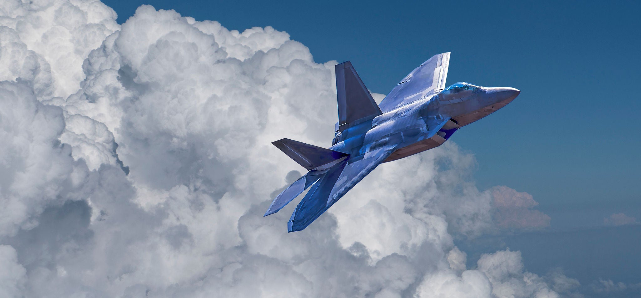 Stealth fighter jet soaring above clouds