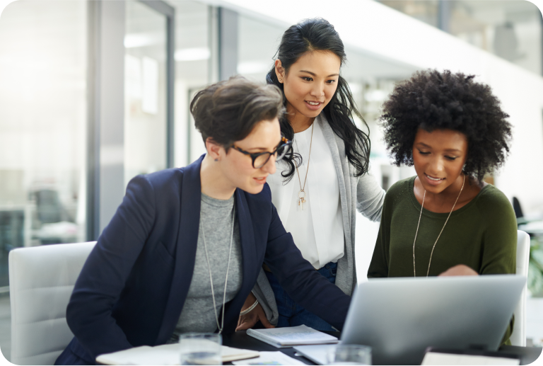 Workers collaborating around laptop