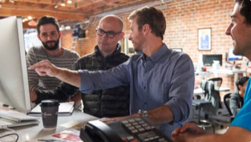 Team meeting around computer